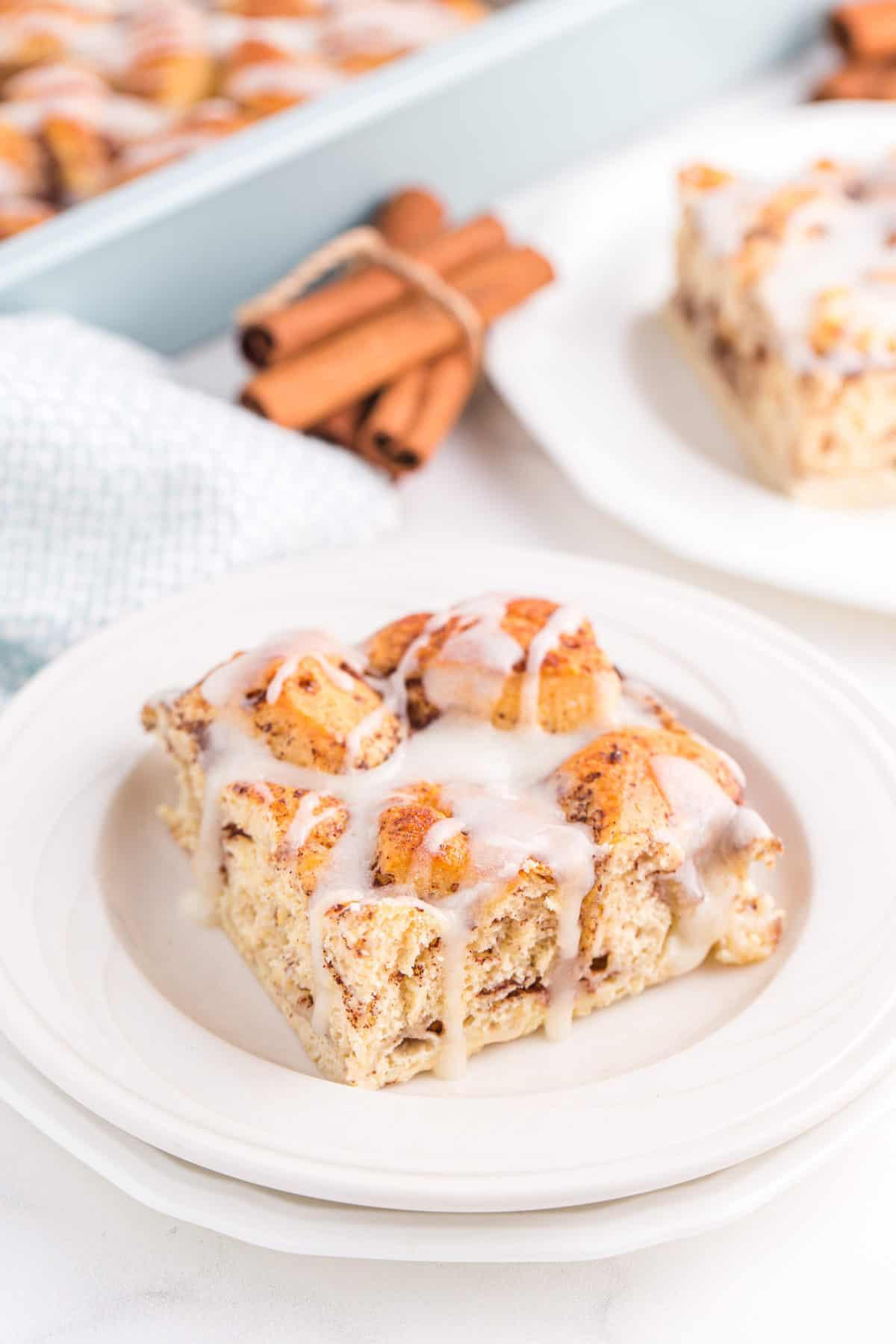 slice of breakfast casserole with icing on white plate