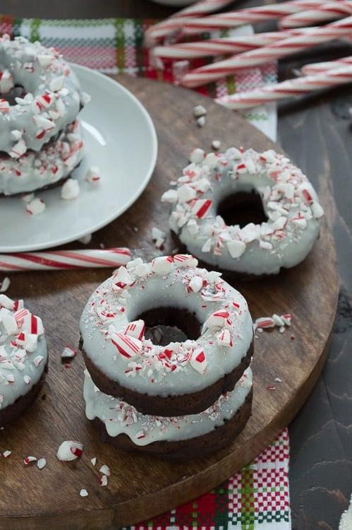 Ciambelle al Cioccolato e Bastoncino di Zucchero 4 Ciambelle al cioccolato cotte al forno, aromatizzate alla menta piperita, guarnite con cioccolato bianco e bastoncini di zucchero tritati.