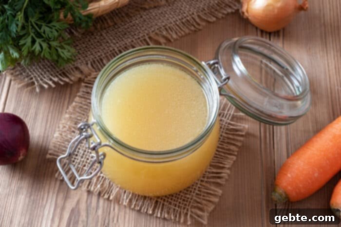 Φτιάξτε τον δικό σας ζωμό λαχανικών 7 Στραγγισμένος σπιτικός ζωμός λαχανικών σε γυάλινο βάζο, έτοιμος για αποθήκευση.