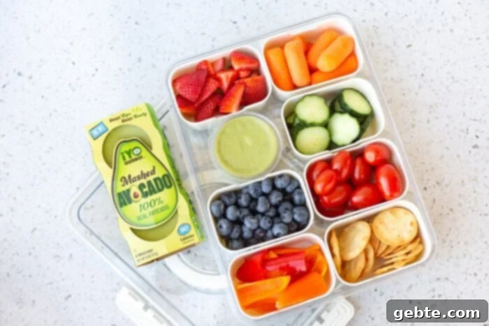 Ανοιξιάτικη Σνακοθήκη 2 Πολύχρωμο Snackle Box γεμάτο με φρέσκα φρούτα και λαχανικά, ιδανικό για τις διακοπές άνοιξης.