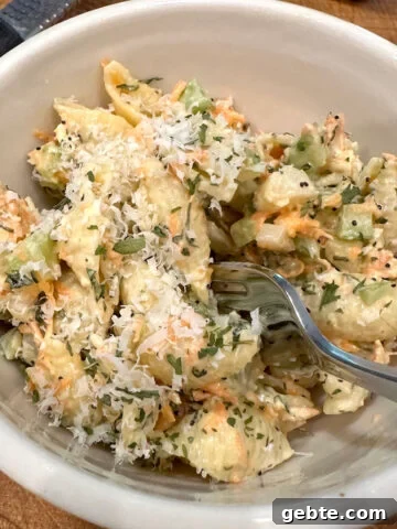 Pasta salad with Italian dressing in a bowl with a fork.