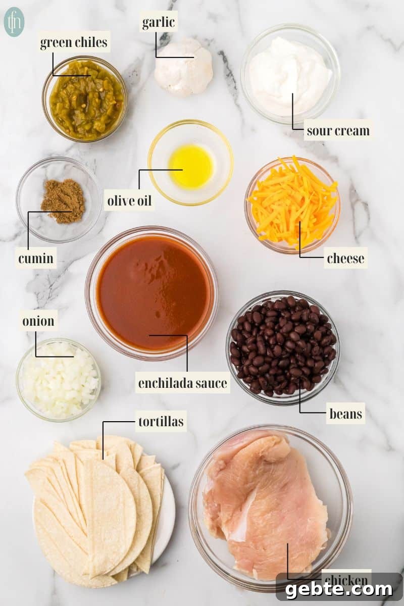 chicken for enchiladas in crock pot ingredients: green chiles, garlic, sour cream, olive oil, cumin, cheese, onion, enchilada sauce, beans, tortillas, and chicken,