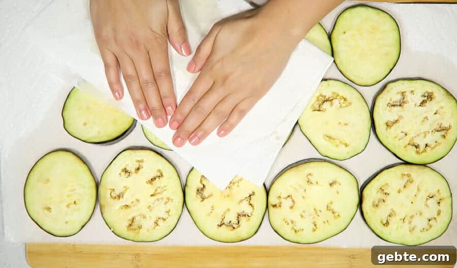 drying off the eggplant rounds with paper towels for the crispy eggplant parmesan