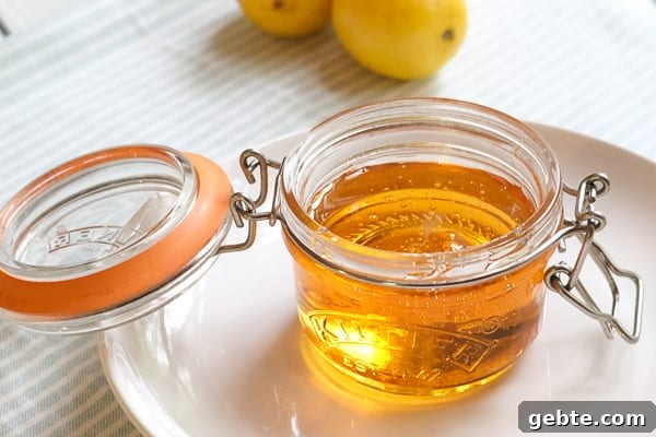 golden syrup inside a small glass jar with an open lid