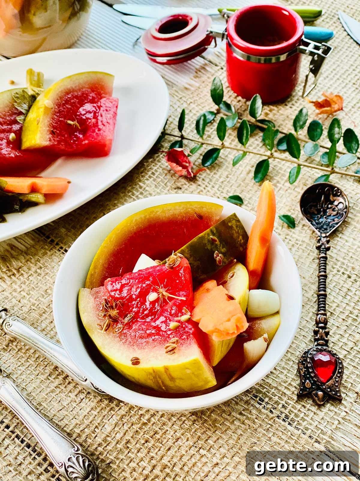 Tangy Pickled Watermelon Rind Recipe for Summer Snacks 2 Pickled watermelon slices with pickled carrot in a white serving dish and a few more slices at the back top left side in an oval white plate