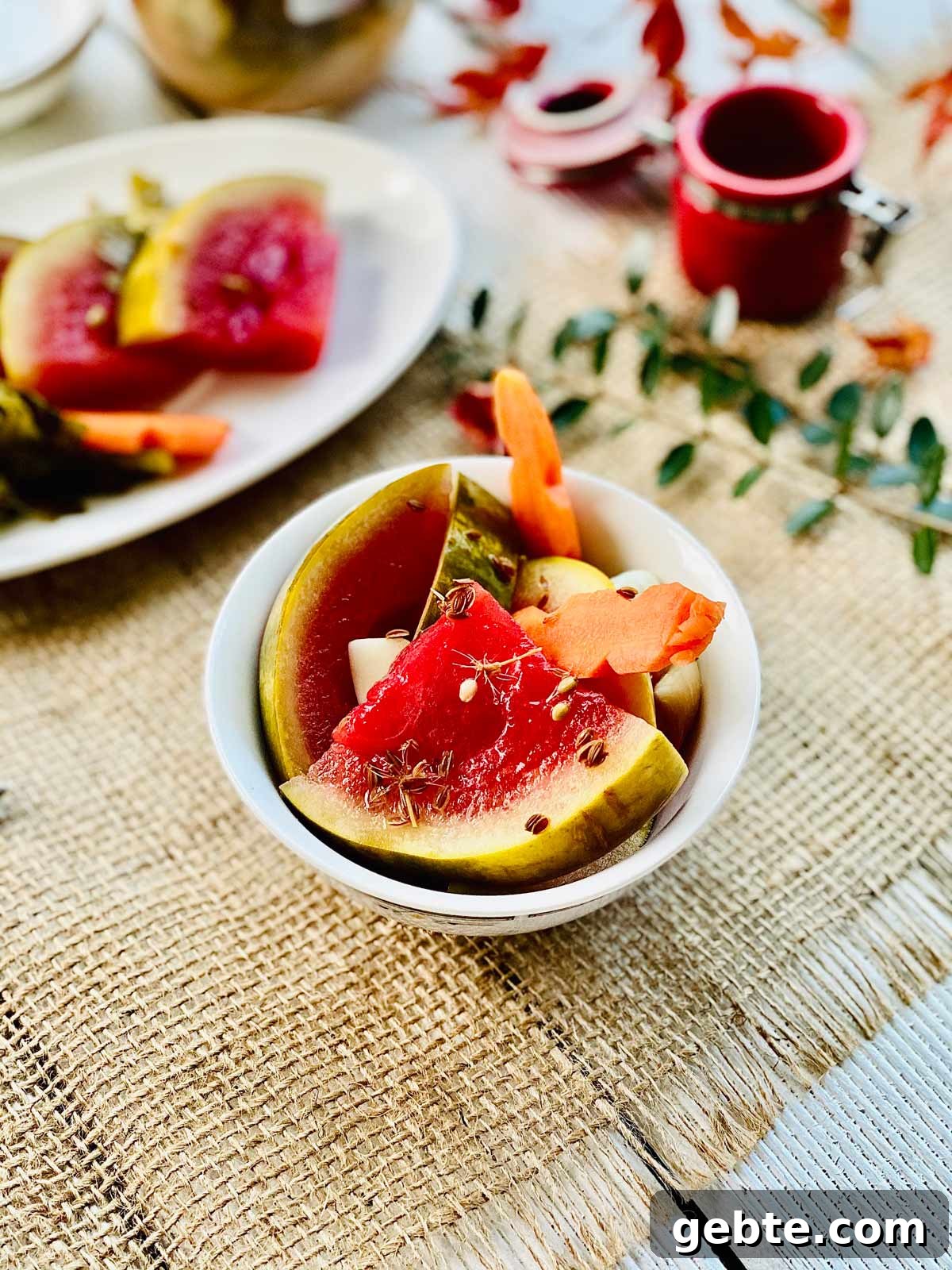 Tangy Pickled Watermelon Rind Recipe for Summer Snacks 4 Pickled watermelon quarter slices with pickled carrot in a white serving dish