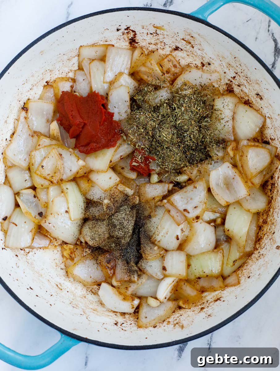Hearty Oven-Braised Beef Stew Recipe for Comforting Dinners 6 Onions and seasoning in a dutch oven