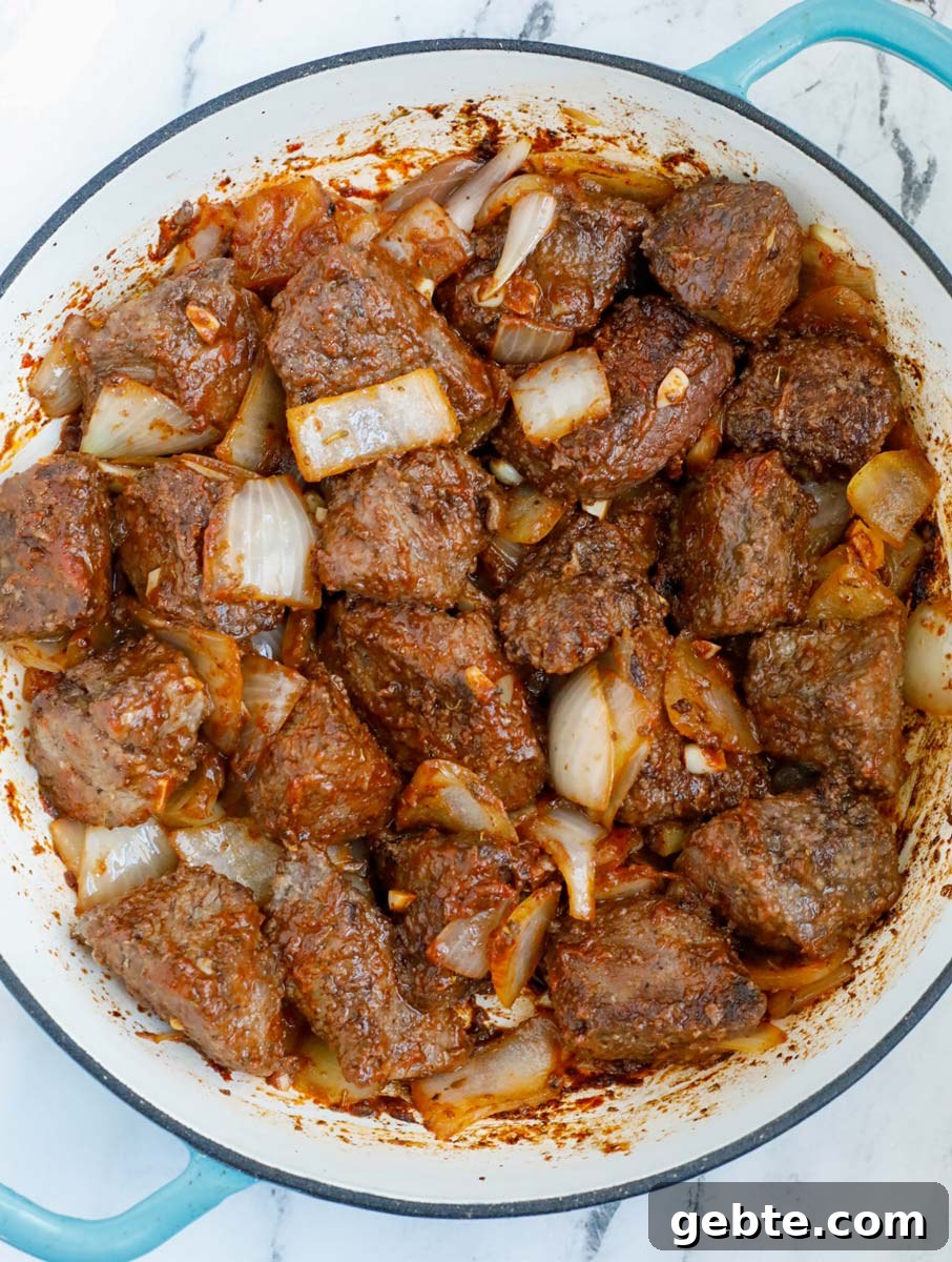 Hearty Oven-Braised Beef Stew Recipe for Comforting Dinners 7 beef sauteed with onions and tomato paste