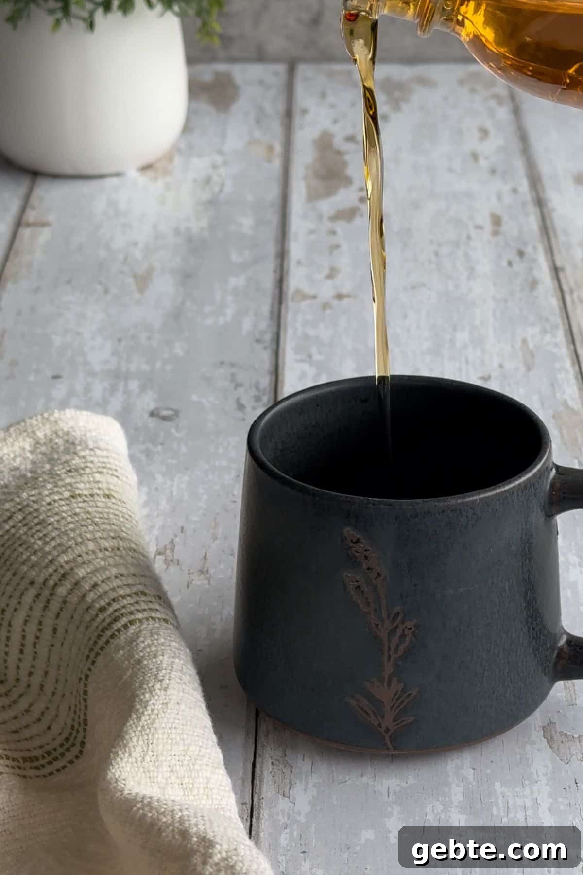 vanilla syrup poured into mug.