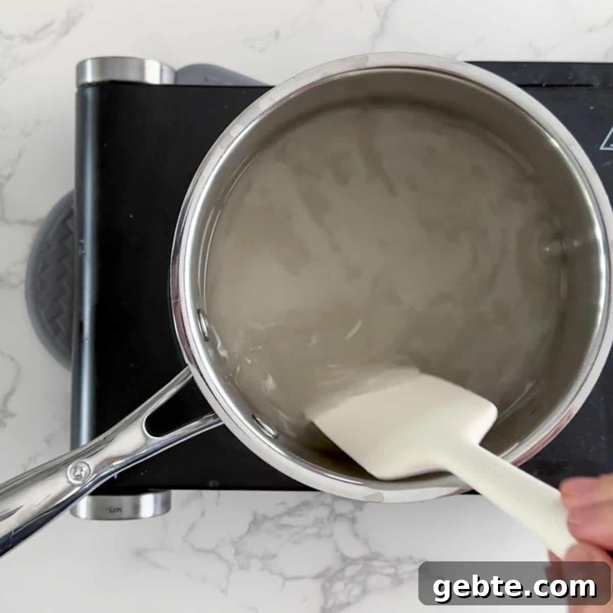 Dissolving sugar in a pan of water.