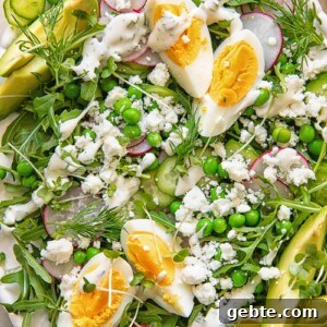 Spring Pea & Arugula Salad with Creamy Dill Dressing 6 top down view of a salad on a platter topped with boiled egg wedges, peas, feta and avocado