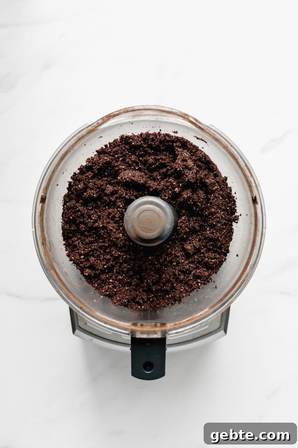 a food processor with blended raw brownie mix