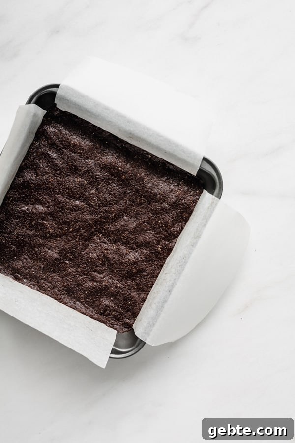an 8x8 inch pan with raw brownies in it