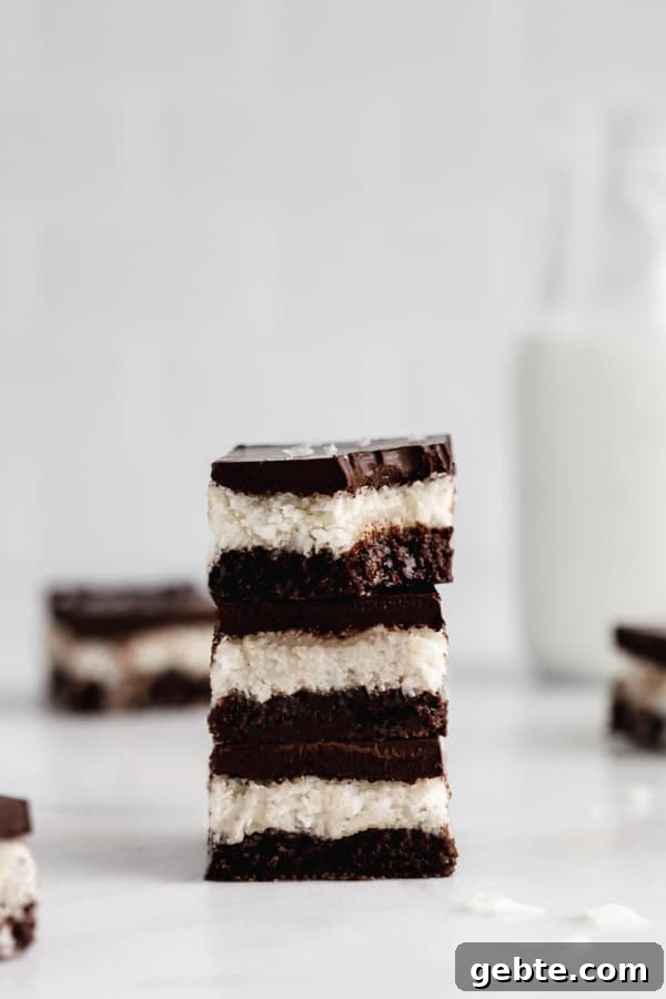 a stack of three no bake coconut brownies