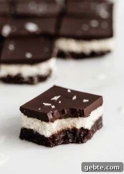 a no bake coconut brownie with a bite taken out of it