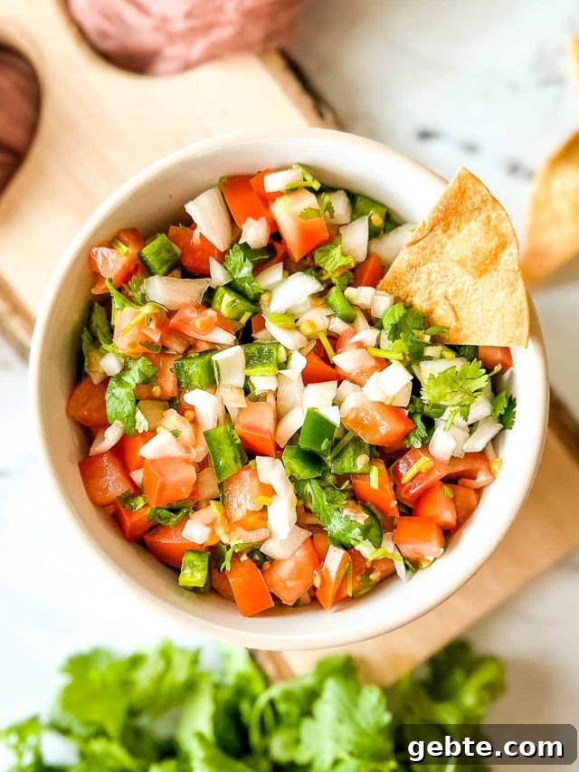 7 Most Popular Salsas and How to Use Them 2 Garden fresh salsa in a white bowl on a vintage wooden cutting board.