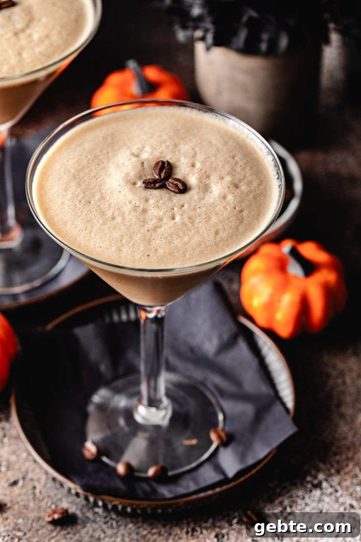 Pumpkin Spice Espresso Martini Recipe for Fall Cocktails 3 Pumpkin spice espresso martini next to a pumpkin.