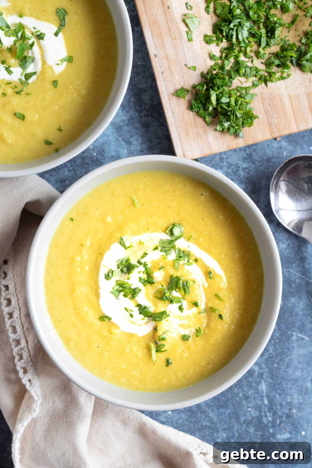 Curried Parsnip and Apple Soup Recipe for Cozy Fall Meals 6 Spiced parsnip and apple soup in bowls with a creme fraiche drizzle.