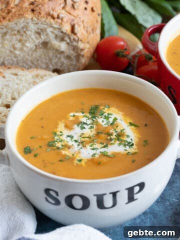 Roasted swede soup in a white soup bowl.