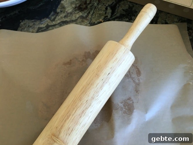 Rolling out the dough with a rolling pin.