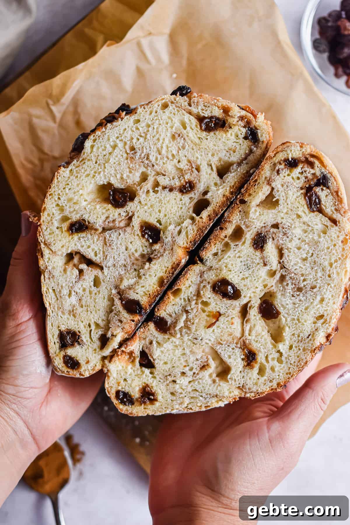 A hand is holding the cut in half bread.