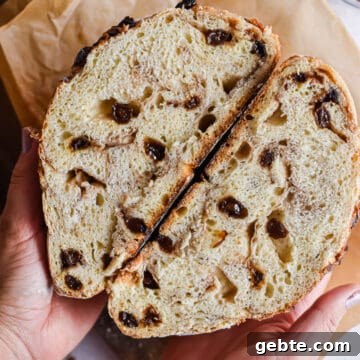 A hand is holding the cut in half bread.