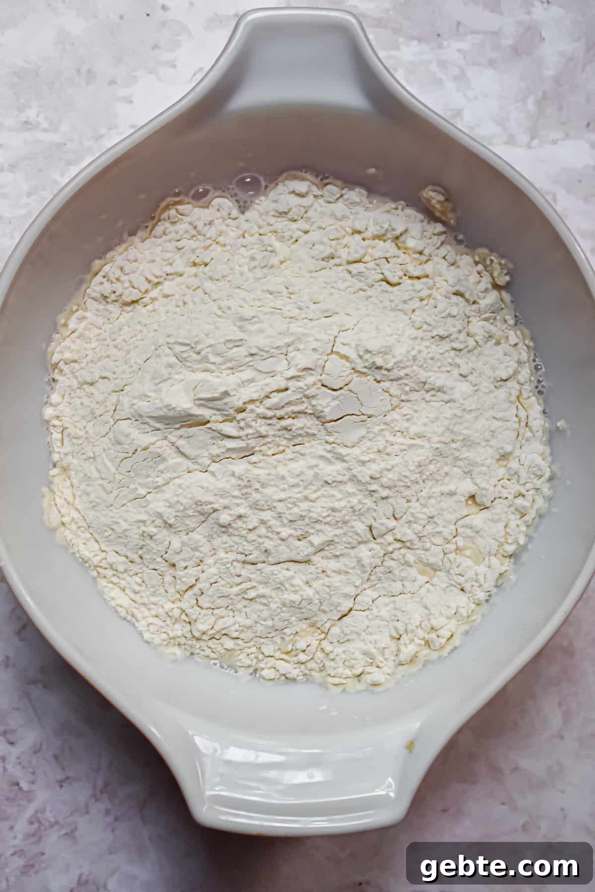 The flour and salt are added to the bowl