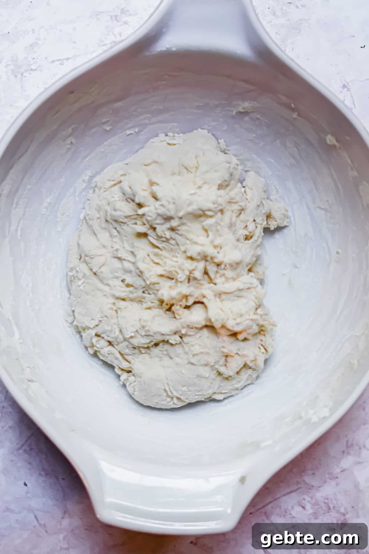 A shaggy dough has formed in the bowl.