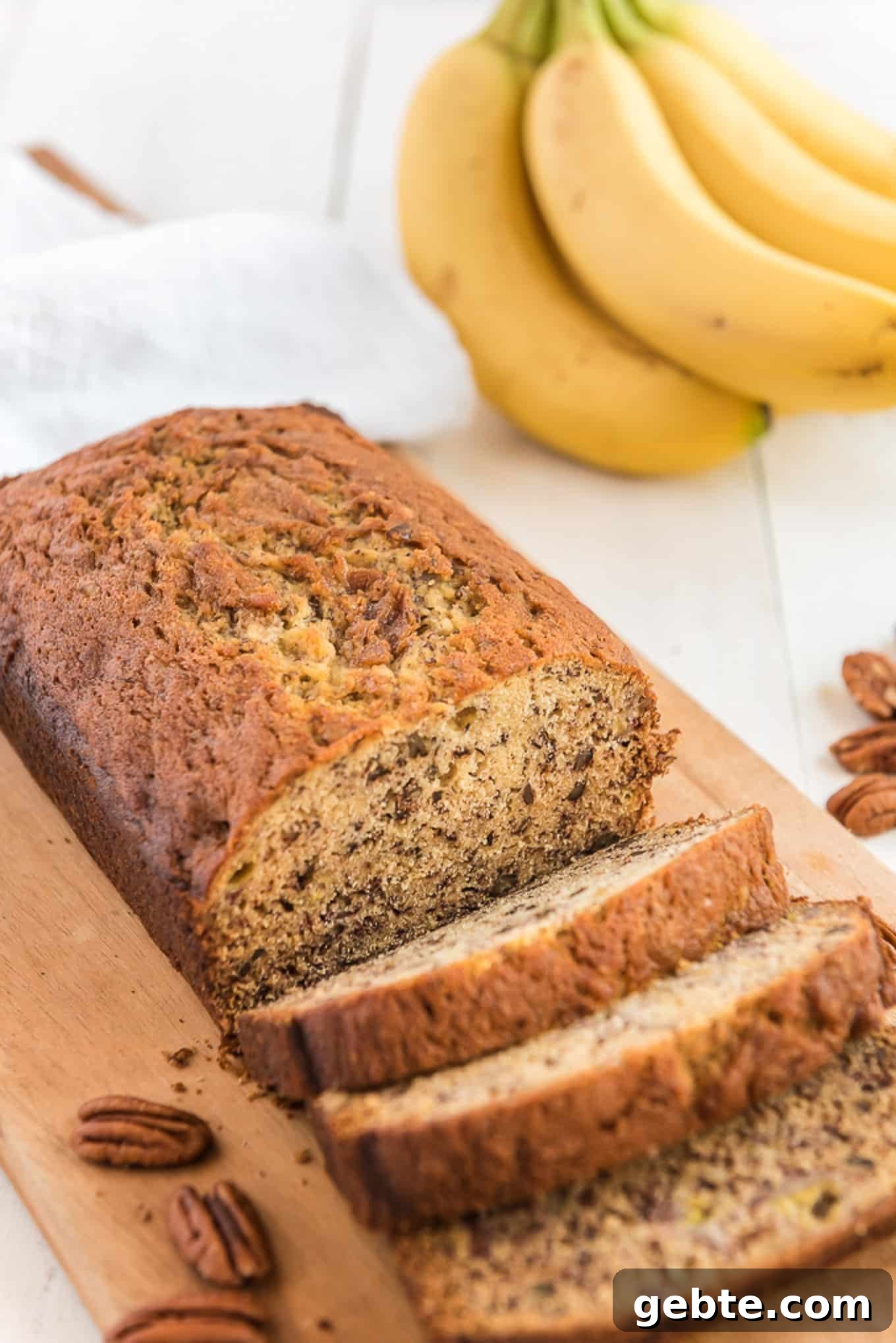 Sliced banana bread on a cutting board.