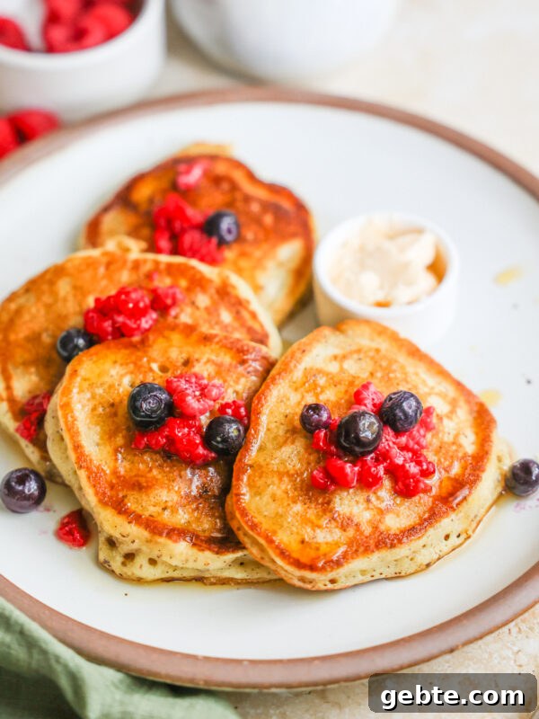 Fluffy Oat Flour Pancakes: Light, Tender Morning Stack 14 A plate of sourdough discard pancakes with berries.