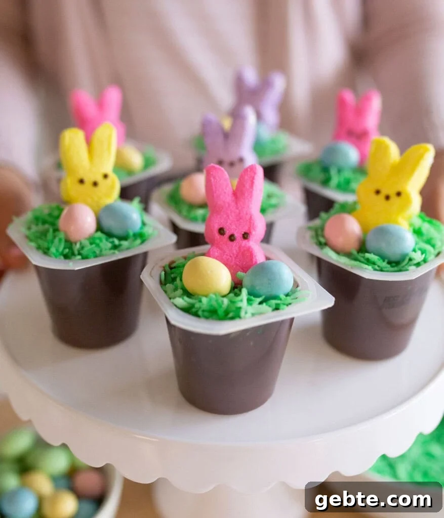Easter bunny pudding cups displayed on a white cake stand.