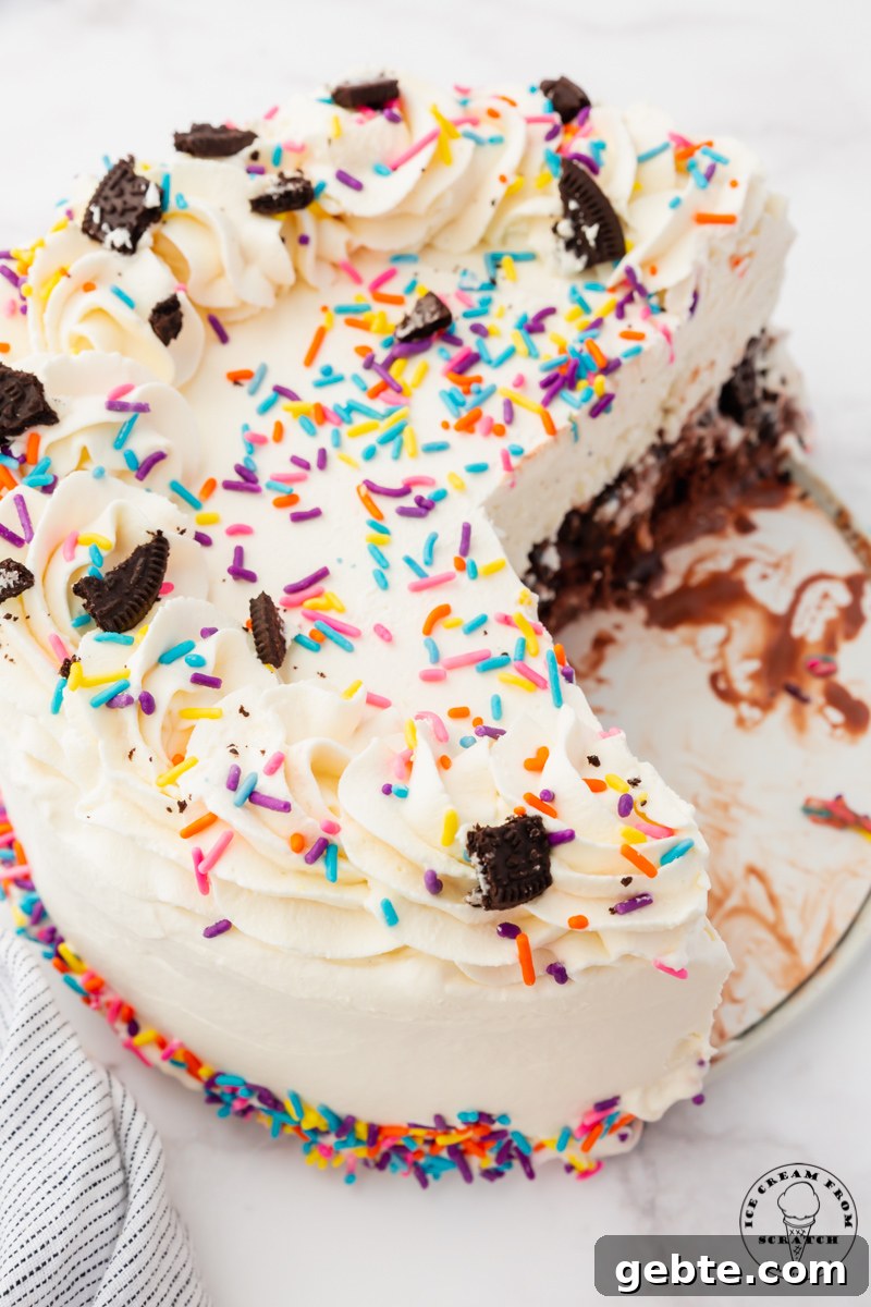 top view of a round cream cake decorated with sprinkles that has had 3 slices removed.