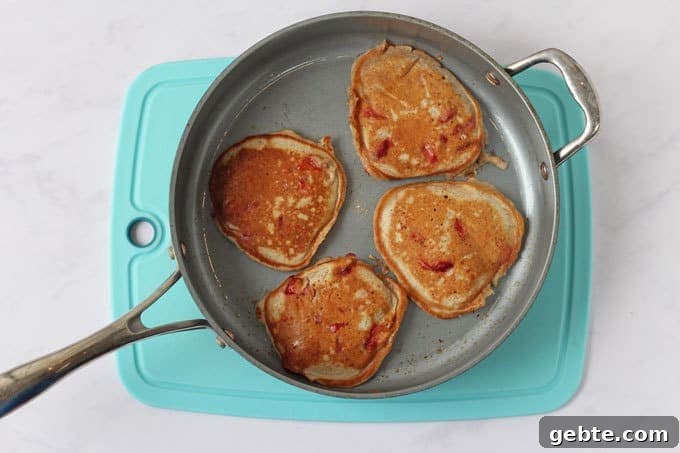 Frying pan with four strawberry yogurt pancakes