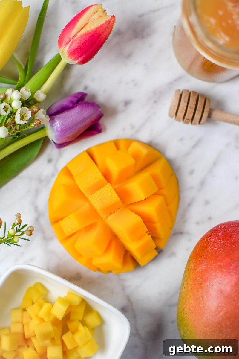 Mango Cannabis Smoothie Bowl Recipe for Relaxing Mornings 4 Springtime Mango Smoothie Bowl with Edible Flowers by Emily Kyle Nutrition