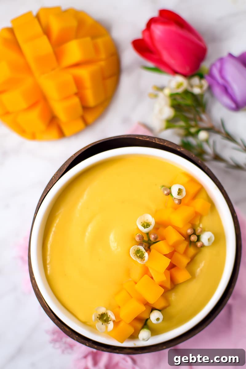 Mango Cannabis Smoothie Bowl Recipe for Relaxing Mornings 5 Springtime Mango Smoothie Bowl with Edible Flowers by Emily Kyle Nutrition