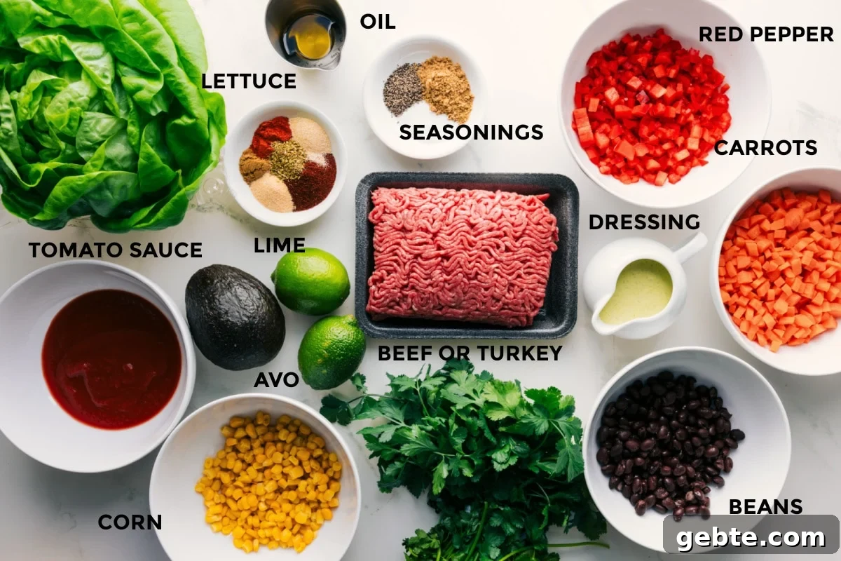 Ingredients prepped for turkey lettuce wraps including lettuce, tomato sauce, corn, avocado, spices, limes, beans, and vegetables.