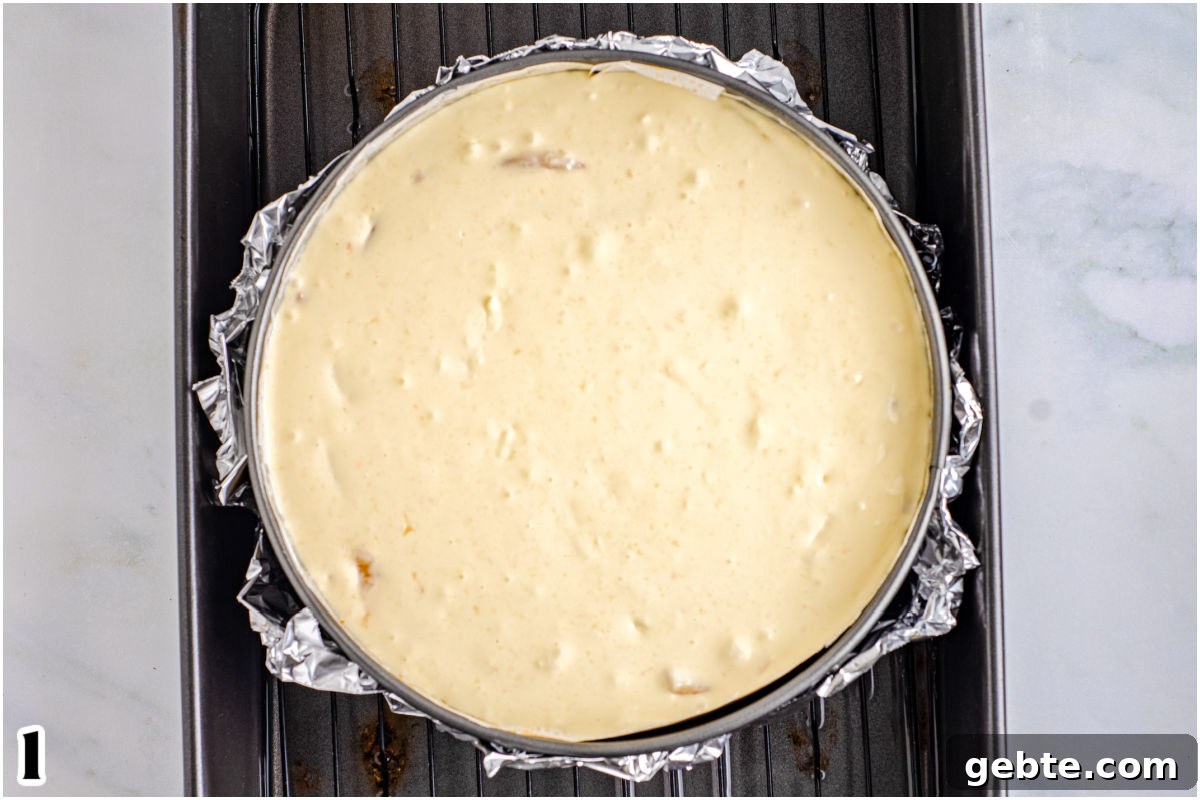 Creamy Peach Cheesecake Recipe with Fresh Peach Topping 7 The cheesecake filling in a springform pan ready to be baked.