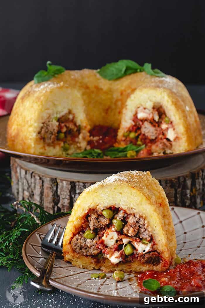 Neapolitan Sausage Meatball Rice Timbale (Sartù di Riso alla Napoletana) 2 A front shot of rice bundt slice with the rest of the dish in background
