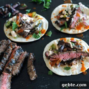 Grilled Skirt Steak Tacos with Charred Lime and Cilantro 11 grilled skirt steak tacos on black background
