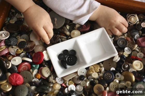 toddlers sorting black buttons for their ladybugs