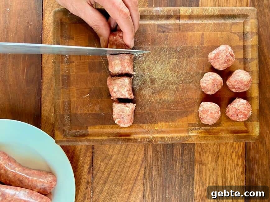 One-Pot Sausage and Meatball Pasta Skillet 6 Slicing sausage meat and rolling into meatballs.