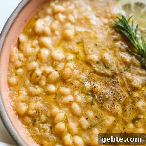 Creamy Instant Pot White Beans with Lemon and Rosemary 11 Creamy instant pot white beans in a bowl.