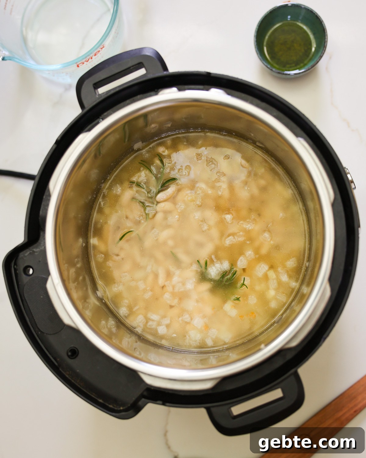 Creamy Instant Pot White Beans with Lemon and Rosemary 6 Beans and water added to the Instant Pot.