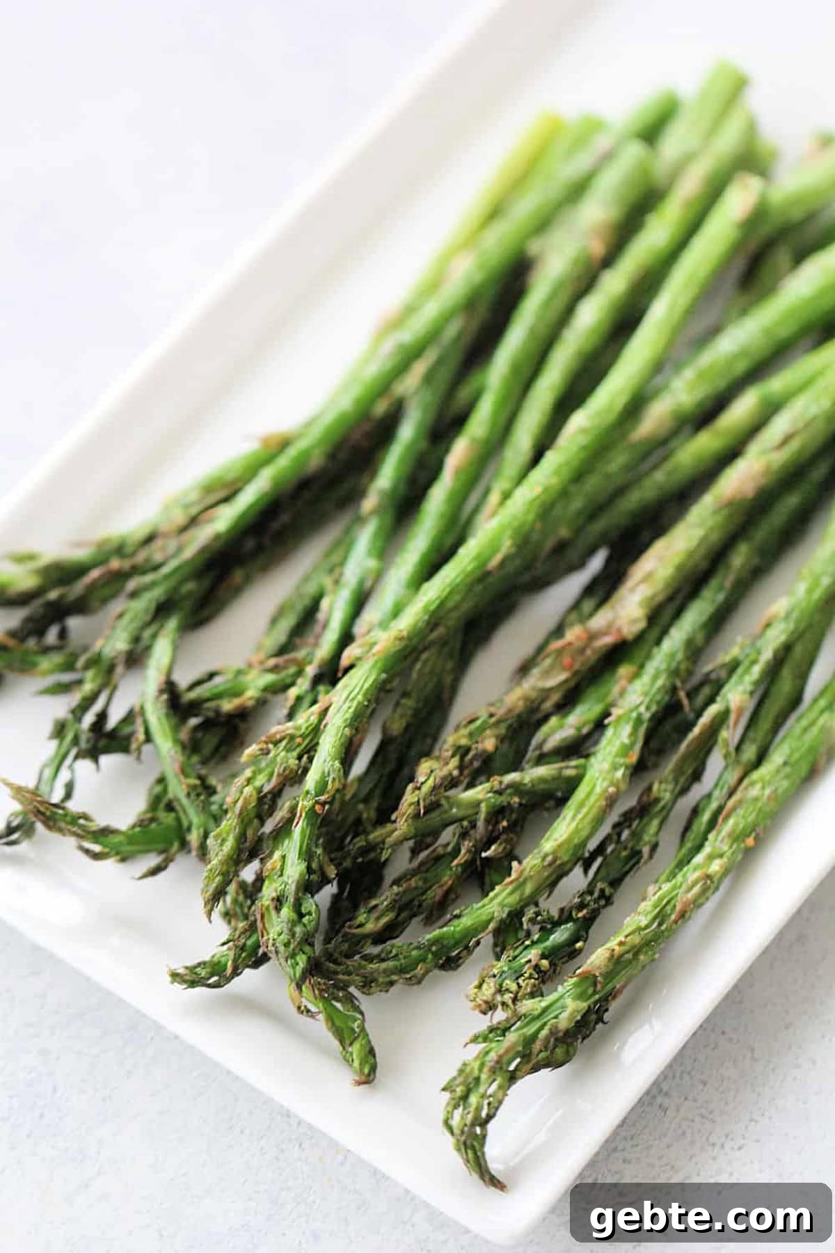 Air Fryer Asparagus on a white serving platter.