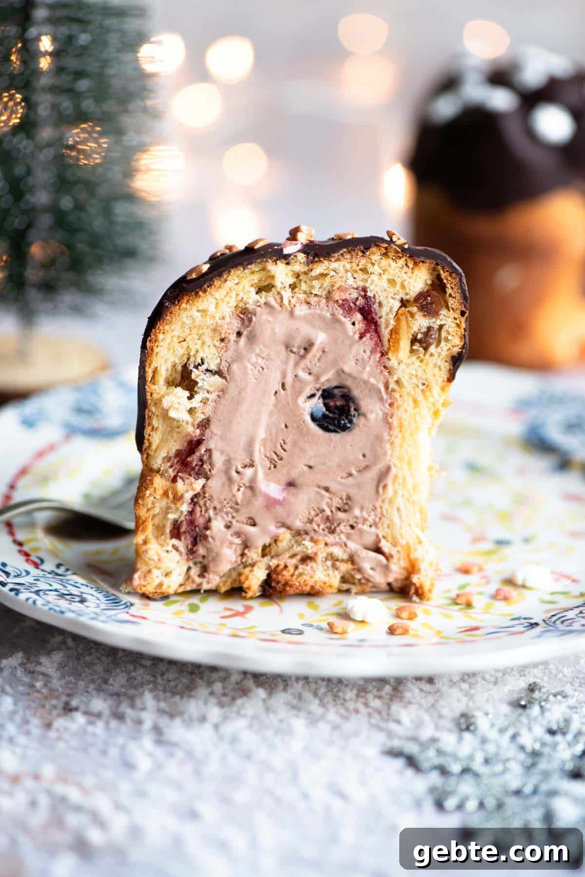 A mini Panettone cut in half showing it stuffed with cherry and chocolate ice cream.