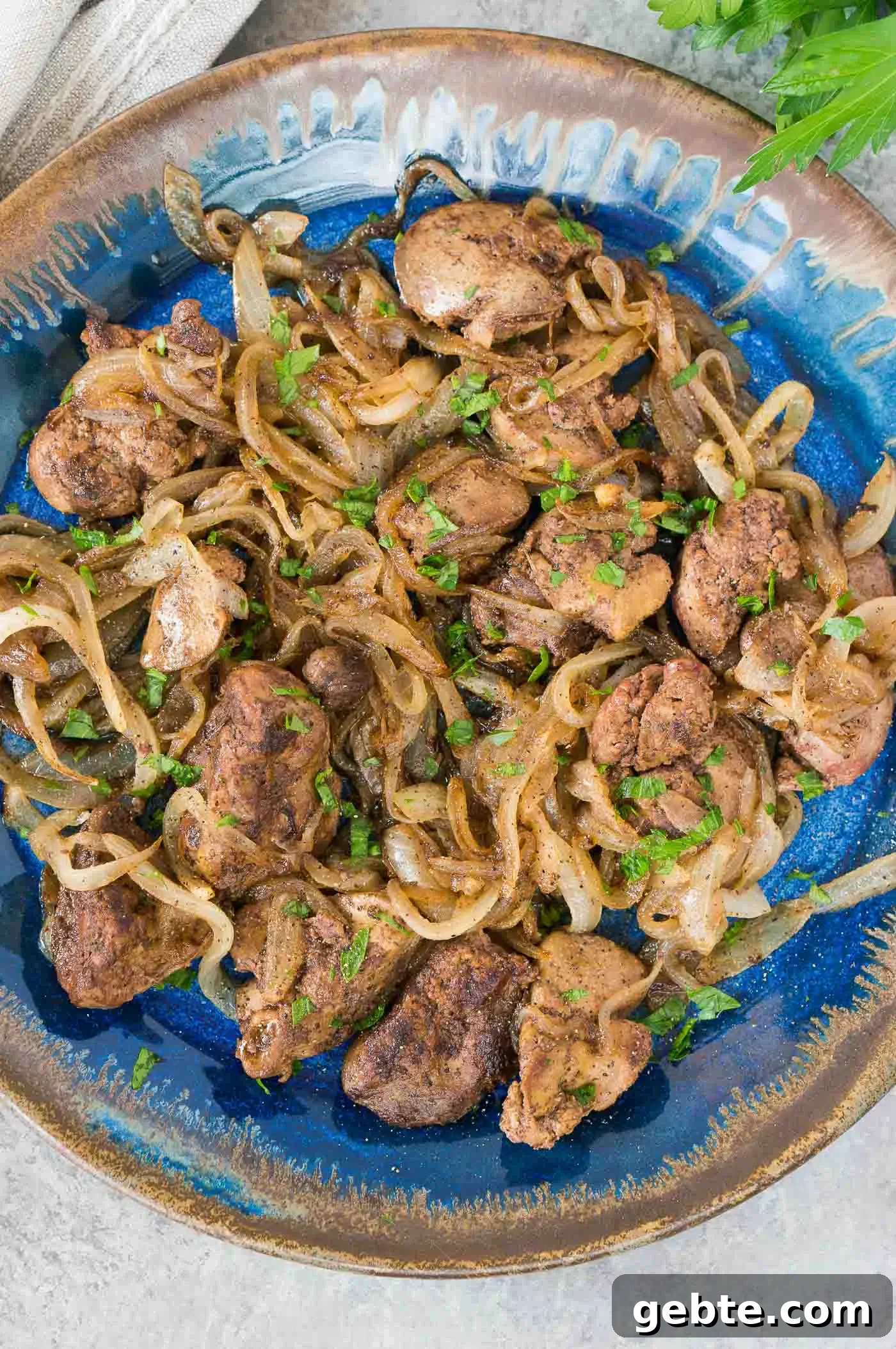 close up image from top of livers and onions on a plate