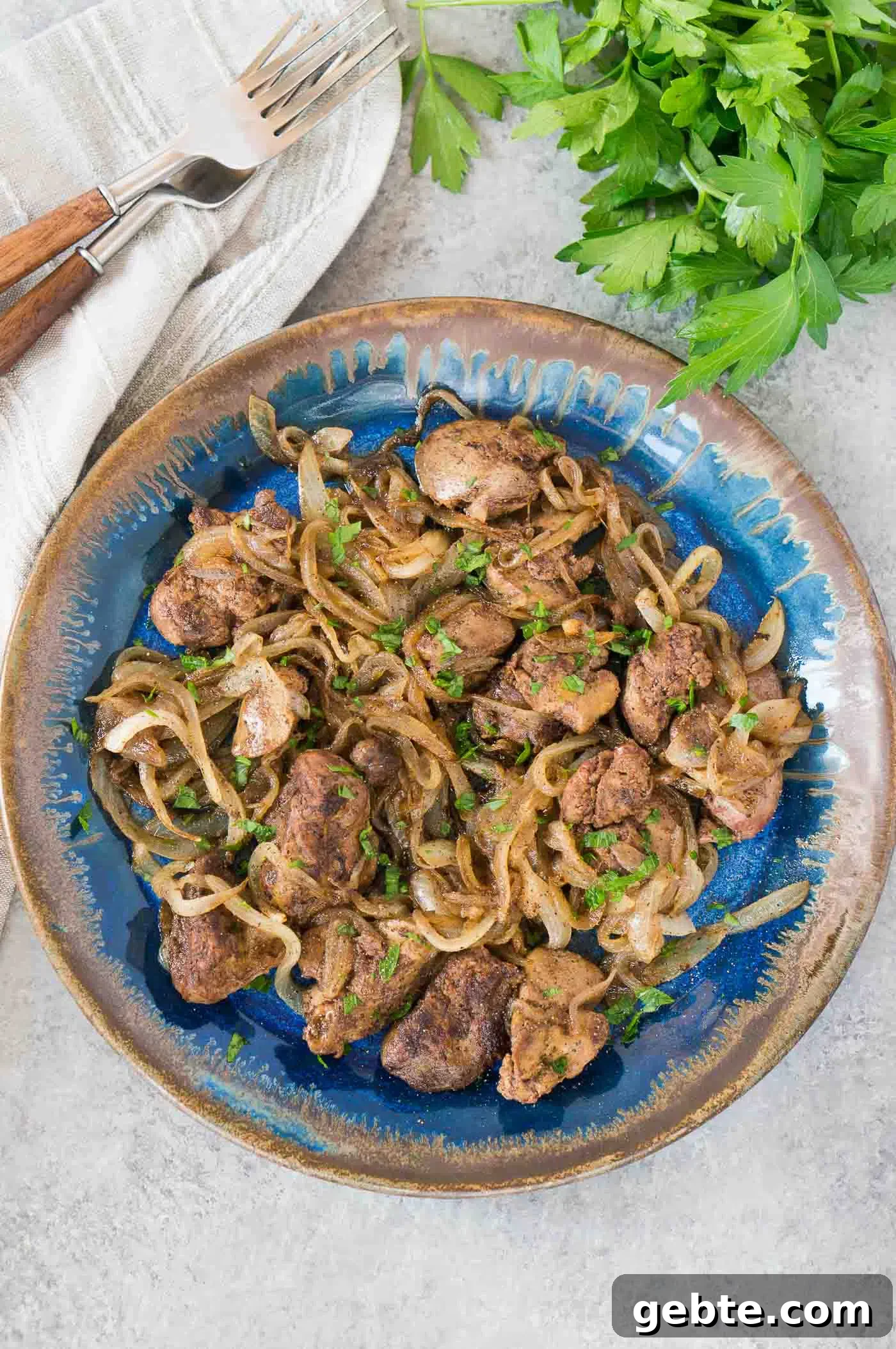 delicious chicken livers and onions served on a plate