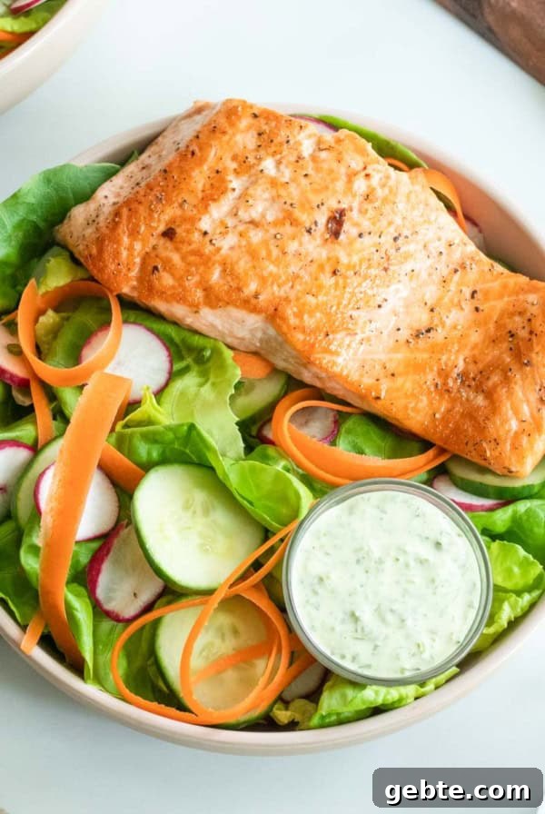 Seared salmon salad on a marble table.