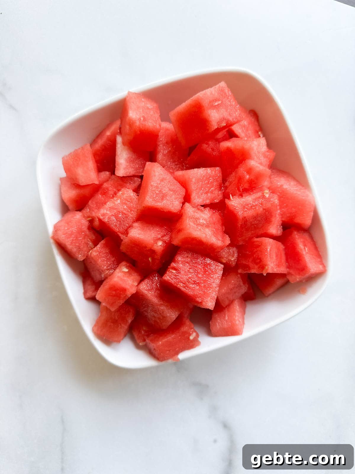 A white bowl with bright, cubed watermelon.