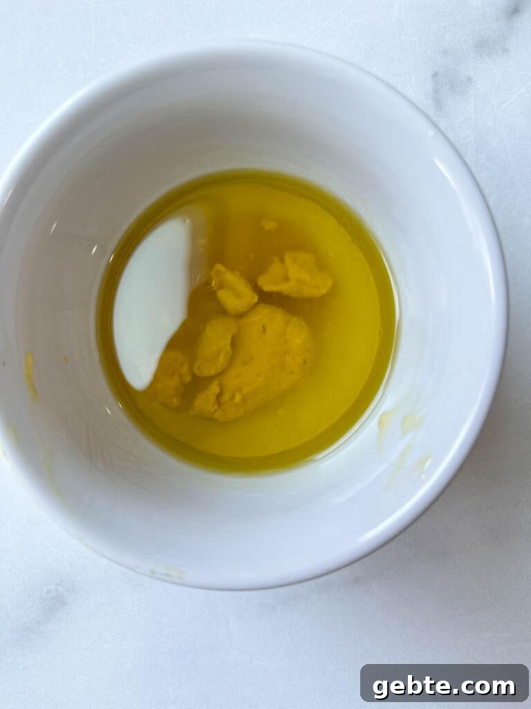 Ingredients for vinaigrette in a white bowl.